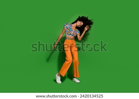 Full length body photo of chill vibes young funky girl with chevelure flying hair dancing night club isolated on green color background