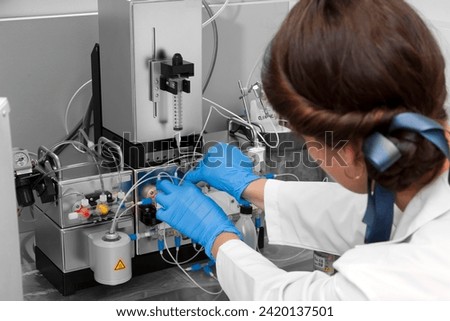 Technician preparing chemical radioactive contrast agent medicine for radiology and nuclear medicine and molecular imaging	 Royalty-Free Stock Photo #2420137501