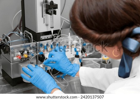 Technician preparing chemical radioactive contrast agent medicine for radiology and nuclear medicine and molecular imaging	 Royalty-Free Stock Photo #2420137507