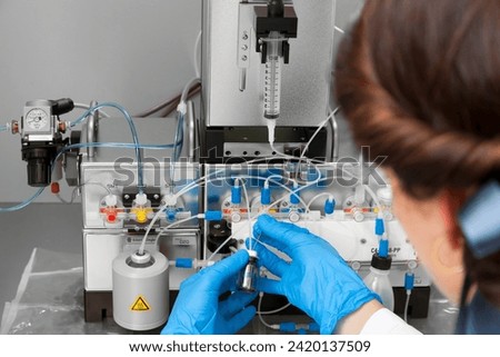Technician preparing chemical radioactive contrast agent medicine for radiology and nuclear medicine and molecular imaging	 Royalty-Free Stock Photo #2420137509