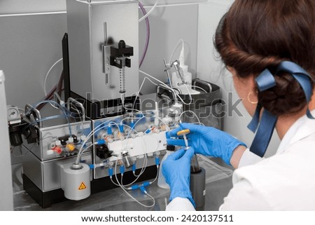 Technician preparing chemical radioactive contrast agent medicine for radiology and nuclear medicine and molecular imaging	 Royalty-Free Stock Photo #2420137511