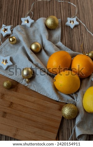 New Year's layout of oranges, board, napkins, garlands and balloons on the kitchen table.Preparations for the holiday.Preparing for the celebration of Christmas.The concept of a cozy kitchen