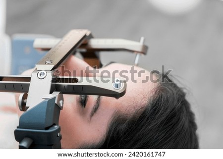 The patient lies in front of the device for the treatment of cancer with a gamma knife. She has a metal clip cap on his head. Gamma Knife stereotactic radiosurgery. Royalty-Free Stock Photo #2420161747