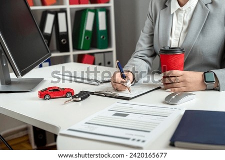 Happy woman signs a contract loan agreement, purchase new car or rent vechicle at office. Car finance and insurance concept