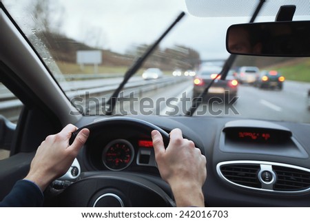 driving in hard weather conditions, rain on the windshield Royalty-Free Stock Photo #242016703