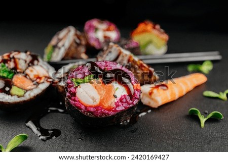 Elegance meets flavor as sushi varieties take their place on a black background, inviting connoisseurs to partake in a visual and gustatory feast at restaurant