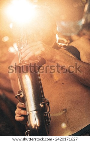 Rio de Janeiro, RJ, Brazil. February, 09, 2016. A musician playing saxophone in a street parade at carnival of Rio de Janeiro.