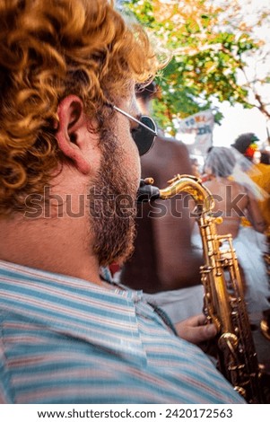Rio de Janeiro, RJ, Brazil. February, 18, 2017. A musician playing saxophone in a street parade at carnival of Rio de Janeiro.