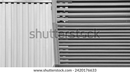 Airflow efficiency: Aluminium grille for industrial air recirculation. Black  white photo, at modern commercial building. Creating original background, pattern, texture, tubular lines shape