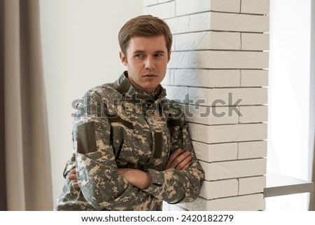 Portrait of military man being deep in thoughts feeling sorrowful
