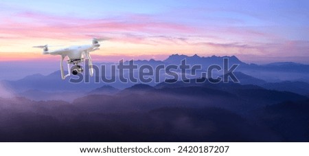 Drone surveys with digital camera Drone with high resolution digital camera Flying camera takes photos and videos Drone with professional camera takes photos of misty mountains.