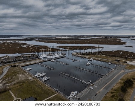 An aerial view of a mostly empty marina in the off season, on a cloudy day on Long Island, New York. Royalty-Free Stock Photo #2420188783
