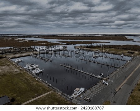 An aerial view of a mostly empty marina in the off season, on a cloudy day on Long Island, New York. Royalty-Free Stock Photo #2420188787