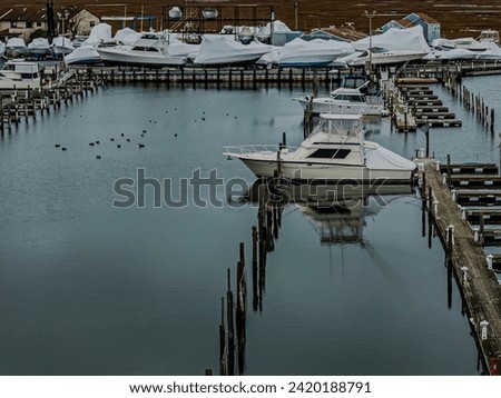 An aerial view of a mostly empty marina in the off season, on a cloudy day on Long Island, New York. Royalty-Free Stock Photo #2420188791