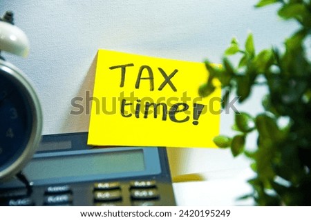 Tax reminder Tax Time! remark for business and individual tax plan budget 2024 with clock and green tree foreground on the calculator copy space stock photo