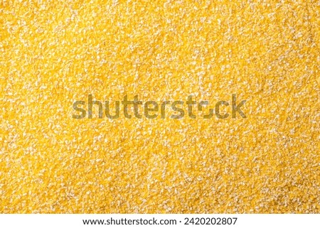 The texture of corn groats. Crushed corn for food. An ingredient for porridge and corn soups. Royalty-Free Stock Photo #2420202807