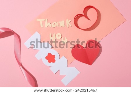 Paper letters arranged combined form the word “Thank you Mom” with red paper hearts and a pink ribbon. International Women's Day is a public holiday in several countries