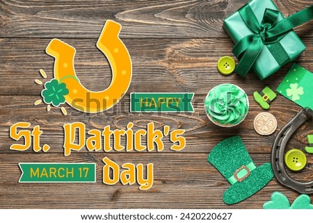 Greeting card for St. Patrick's Day with party decorations on wooden background