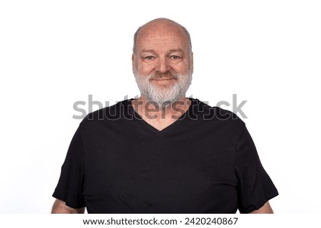 Smiling Middle-Aged Bearded Man in Black T-Shirt - Confident Casual Portrait on White Background.
