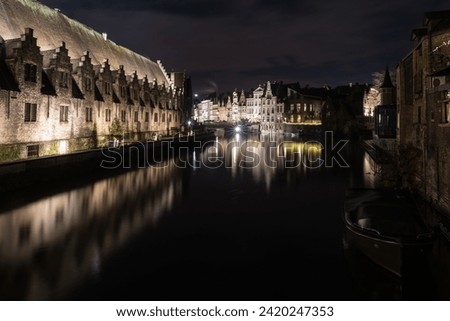 Groot Vleeshuis in Ghent Belgium. Night picture in color, with reflections in the river.
