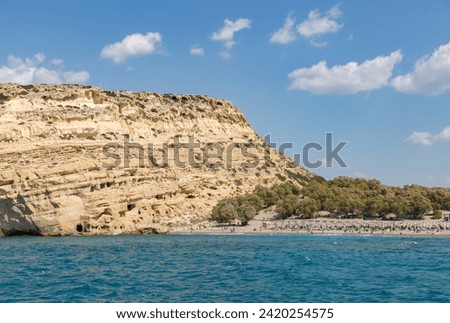 A picture of the Matala Beach, with the Matala Caves on the left side.
