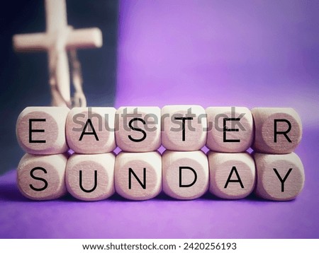 Lent, Holy Week, Good Friday, Easter Sunday Concept - Easter Sunday text on wooden cubes with blurry cross shape background. Stock photo Royalty-Free Stock Photo #2420256193