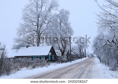 Village street covered with snow on a frosty winter day
