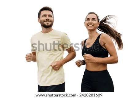 Dynamic image of a man and woman running together in sportswear, expressing vitality and enjoyment, isolated on white. Royalty-Free Stock Photo #2420281609