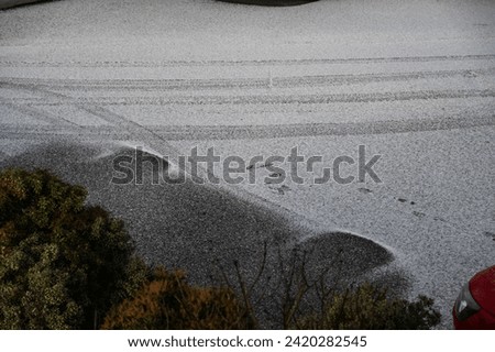 Snowy outline of a car that has left.