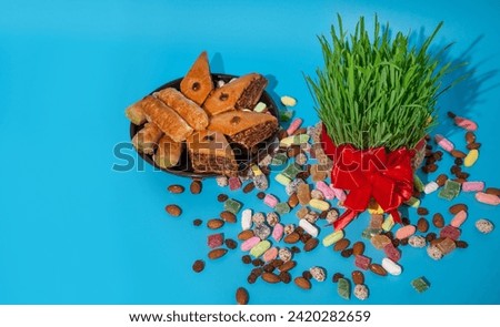 The vernal equinox, a traditional table on Navruz. wheat grass, Arabic baklava dessert, sweets, nuts, dried fruits.