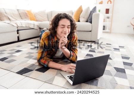 Photo of thoughtful funky guy wear plaid shirt lying floor texting emails modern gadget indoors room home house Royalty-Free Stock Photo #2420294525