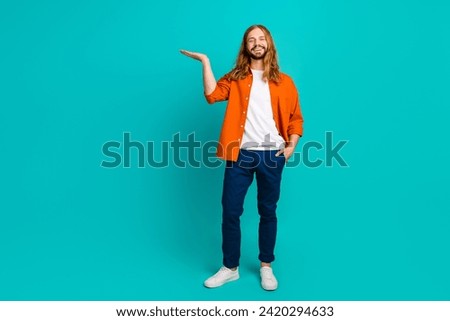 Full length photo of model man blond long hair model promoting his lotion for healthcare holding palm isolated on cyan color background