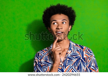Photo of amazed guy touch chin looking empty space curious interested watching wild animals on island isolated over green color background Royalty-Free Stock Photo #2420294655