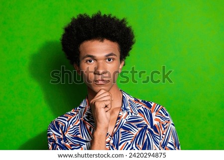 Photo of young confident serious guy keep calm intelligent student in university touch chin deep thinking isolated on green color background