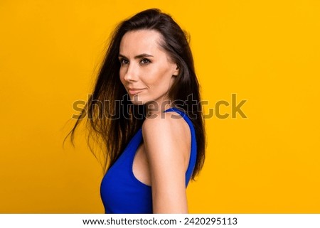 Photo of adorable shiny lady dressed blue top smiling empty space isolated yellow color background