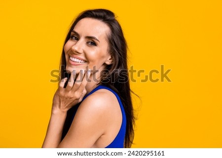 Photo of dreamy pretty lady dressed blue top arm hand cheek cheekbone empty space isolated yellow color background