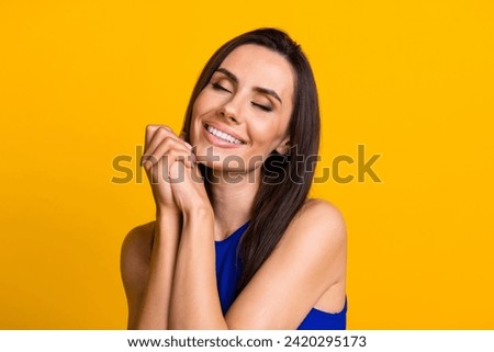 Photo of sweet shiny woman wear blue top arms chin closed eyes isolated yellow color background