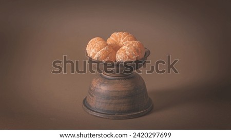 Three Tangerines in a clay plate. 6k. Poster 16:9 Royalty-Free Stock Photo #2420297699