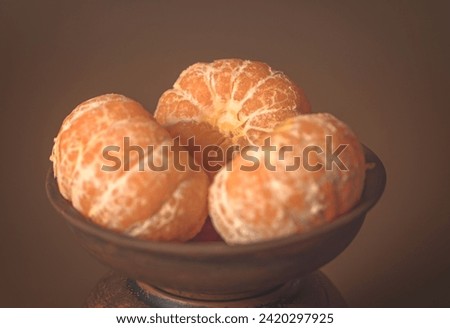 Poster. Three Tangerines in a clay plate. 6k Royalty-Free Stock Photo #2420297925