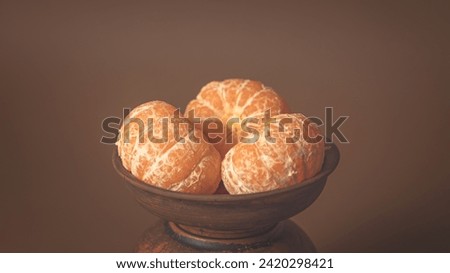 Poster 16-9 Three Tangerines in a clay plate. 6k Royalty-Free Stock Photo #2420298421