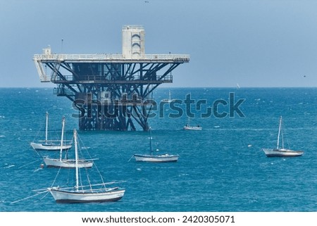 Oil extraction in northern Peru. Oil Platform in the sea near Cabo Blanco with anchored boats around. El Alto and Talara, oil-rich locations. Royalty-Free Stock Photo #2420305071