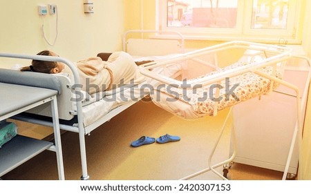 A ward with a young mother without a face. bed for a newborn.