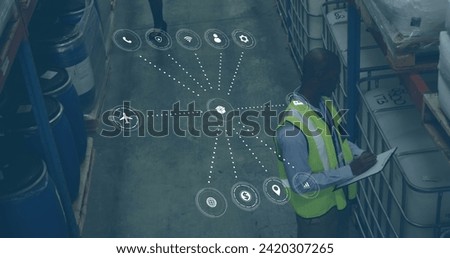 Image of data processing with icons over african american man working in warehouse. Global shipping, networks, digital interface, computing and data processing concept digitally generated image.