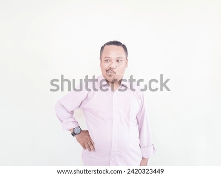 A brown-skinned Asian man wearing a pink shirt with a white background