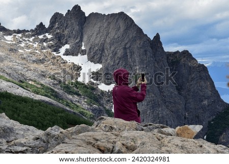 Ain't no mountain high enough – Person resting and taking pictures after hours of trekking. Refugio López, Cerro López, Bariloche, Patagonia Argentina.