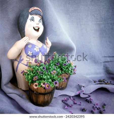 Cute doll with flowers in vase. Photo in old color image style