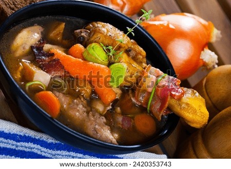 Cock-a-leekie - Scotland national chicken soup with leeks served in black bowl.. Royalty-Free Stock Photo #2420353743