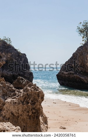 Ocean view among the rocks. Sandy beach and sea view