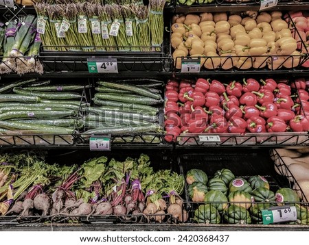 Vegetables in the produce aisle are waiting to be chosen for a meal.