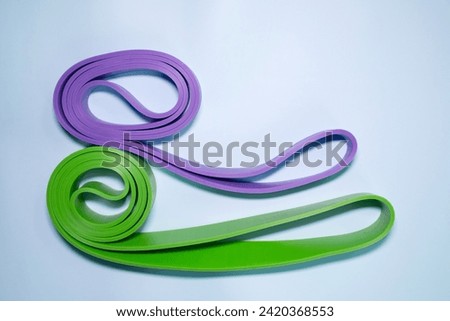 Multicolored exercise rubber band fitness on blue background.